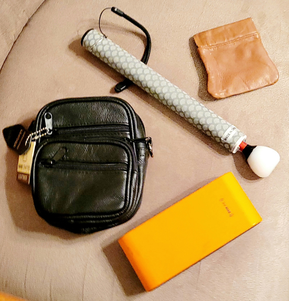 Picture displaying 4 leather and gadget products: gadget bag/large neck puuch; telescoping cane, 